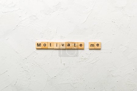Motivate me word written on wood block. Motivate me text on cement table for your desing, concept.
