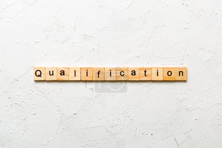 qualification word written on wood block. qualification text on table, concept.