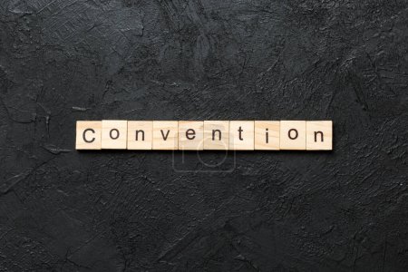 convention word written on wood block. convention text on cement table for your desing, concept.