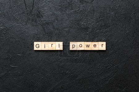 Girl Power word written on wood block. Girl Power text on cement table for your desing, concept.