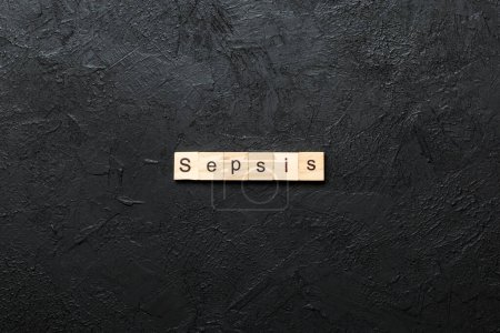 Palabra de sepsis escrita en bloque de madera. Sepsis texto sobre tabla de cemento para su diseño, concepto.