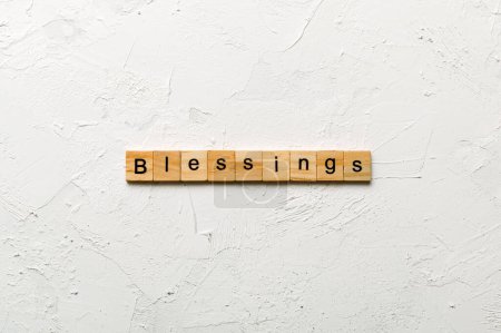 Blessings word written on wood block. Blessings text on cement table for your desing, Top view concept.