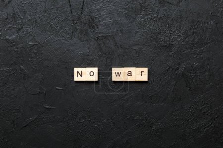 No war word written on wood block. No war text on table, concept.