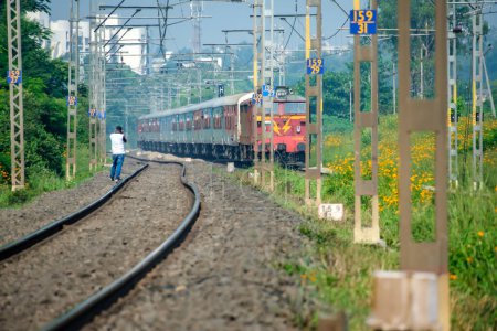 Photo for Pune, India - October 08 2023: WCAM2P electric locomotive hauls a passenger train near Pune India. - Royalty Free Image