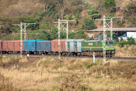 Photo for Pune, India - March 26 2023: WAG9 electric locomotive hauls a freight train near Pune India. - Royalty Free Image