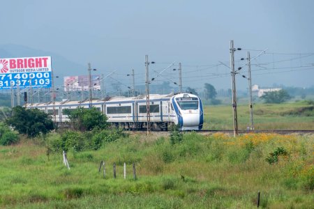 Photo for Pune, India -  October 14 2023: The Solapur Mumbai Vande Bharat Express heading towards Mumbai after the end of monsoon season at Kamshet near Pune India. - Royalty Free Image