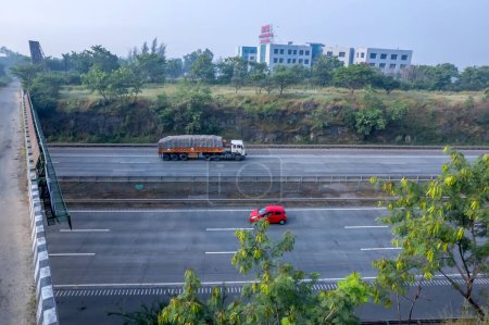 Photo for Pune, India - October 14 2023: Traffic on the Mumbai Pune Expressway near Pune India. The Expressway is officially called the Yashvantrao Chavan Expressway. - Royalty Free Image