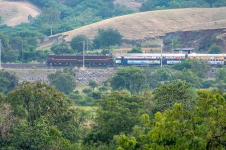 Photo for Pune, India - October 24 2023: WCAM2P electric locomotive hauls a passenger train near Pune India. - Royalty Free Image