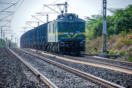 Photo for Pune, India - June 11 2023: WAG9 electric locomotive hauls a freight train near Pune India. - Royalty Free Image