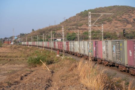 Photo for Pune, India - March 26 2023: WAG9 electric locomotive hauls a freight train near Pune India. - Royalty Free Image