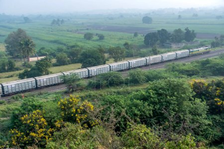 Photo for Pune, India - October 22 2023: WAG9 electric locomotive hauls a freight train near Pune India. - Royalty Free Image