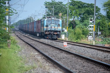 Photo for Pune, India - July 09 2023: WAG7 electric locomotive hauls a freight train near Pune India. - Royalty Free Image