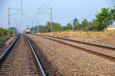 Photo for Pune, India - November 13 2023: Passenger train hauled by a WAP7 electric locomotive near Pune India. - Royalty Free Image