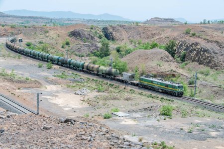 Photo for Pune, India - June 01 2024: Oil tanker train hauled by a WAG9 electric locomotive near Pune India. - Royalty Free Image