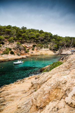 Photo for Cala Falco, a secluded cove nestled on the rugged coastline of Mallorca, Spain. The cove is renowned for its pristine waters, dramatic cliffs, and idyllic atmosphere, making it a true hidden gem for those seeking a tranquil escape. - Royalty Free Image