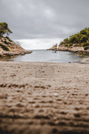 Photo for Cala Falco, a secluded cove nestled on the rugged coastline of Mallorca, Spain. The cove is renowned for its pristine waters, dramatic cliffs, and idyllic atmosphere, making it a true hidden gem for those seeking a tranquil escape. - Royalty Free Image
