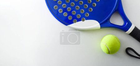 Foto de Padel sport background with racket and ball on white background. Top view. - Imagen libre de derechos