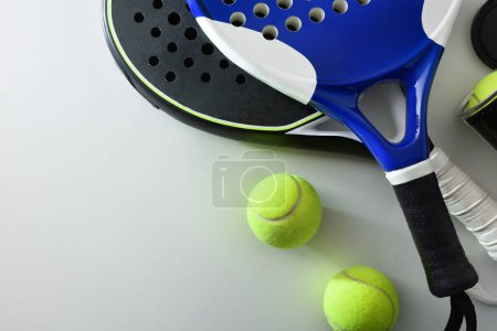 Foto de Two paddle tennis rackets and set of balls on white table. Top view. - Imagen libre de derechos