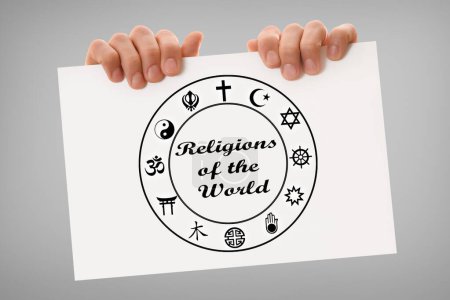 Hands holding a white sign with message of world religions and cultural diversity with drawn symbols and gray isolated background.