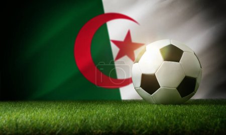 Composition de l'équipe nationale algérienne avec balle classique sur herbe et drapeau en arrière-plan. Vue du dessus.