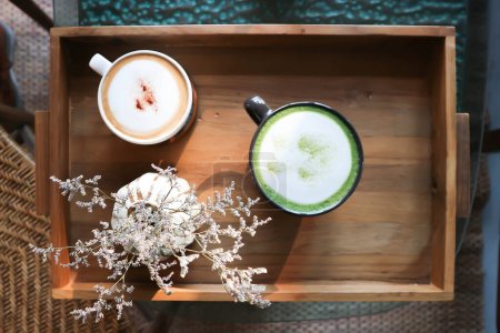 hot cofffee, cappuccino coffee or latte coffee and hot green tea or hot matcha green tea latte and caspia flower in a vase