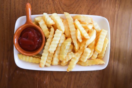 French fries or fried potato , fries or chips with ketchup or tomato sauce