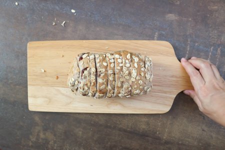 bread , whole wheat bread or sourdough bread or loaf of bread or cranberry and whole grain bread in the wooden tray