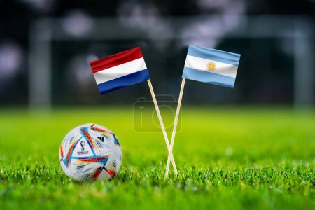 Photo for QATAR, DOHA, DECEMBER 2. 2022: Netherlands - Argentina. Round of 8, Quarter-finals. Official ball of Fifa world cup Qatar 2022 on green grass. Soccer stadium in background. Handmade national flags. - Royalty Free Image
