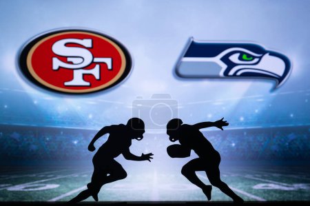Photo for SAN FRANCISCO, USA, JANUARY 10, 2023: Seattle Seahawks vs. San Francisco 49ers. NFL Wild Card Round 2023, Silhouette of American Football Players against each other. Screen in background - Royalty Free Image