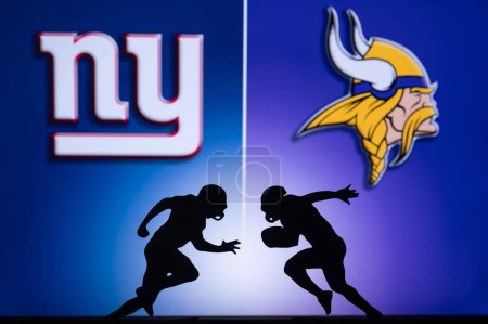 Photo for MINNESOTA, USA, JANUARY 10, 2023: New York Giants vs. Minnesota Vikings. NFL Wild Card Round 2023, Silhouette of two NFL American Football Players against each other. Big screen in background - Royalty Free Image