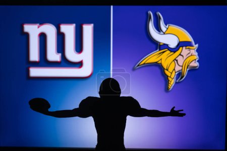 Photo for MINNESOTA, USA, JANUARY 10, 2023: New York Giants vs. Minnesota Vikings. NFL Wild Card Round 2023, Silhouette of NFL player of american football. holding ball in hand. Big screen in background - Royalty Free Image