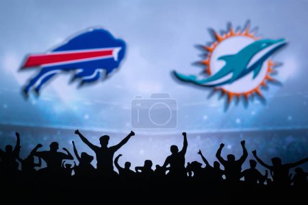 Téléchargez les photos : BUFFALO, USA, JANUARY 10, 2023: Miami Dolphins vs. Buffalo Bills. NFL Wild Card Round 2023, Silhouette of fans supporting the team and cheering for the players during the game. Big screen - en image libre de droit