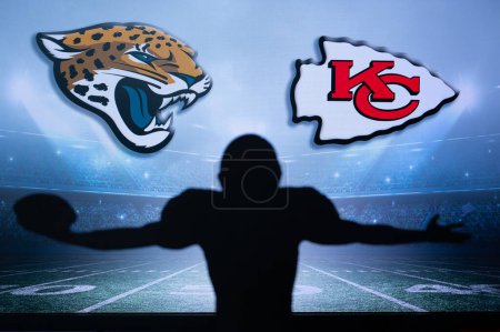 Photo for KANSAS, USA, JANUARY 18, 2023: Jacksonville Jaguars vs. Kansas City Chiefs. NFL Divisional Round 2023, Silhouette of NFL player of american football. holding ball in hand. Big screen in background - Royalty Free Image