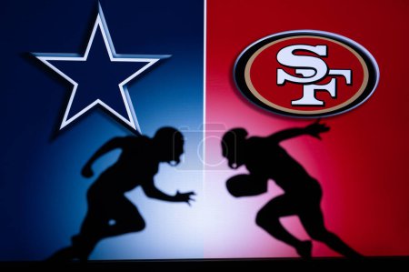 Photo for SAN FRANCISCO, USA, JANUARY 18, 2023: Dallas Cowboys vs. San Francisco 49ers. NFL Divisional Round 2023, Silhouette of two NFL American Football Players against each other. Big screen in background - Royalty Free Image