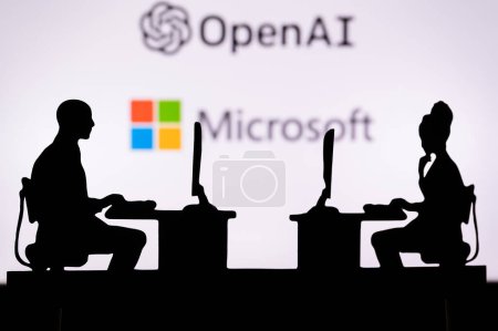 Foto de USA, NEW YORK CITY, JANUARY 30, 2023: Open AI and Microsoft. Pushing Boundaries with Cutting-Edge Software: Two Developers Silhouetted with Company Logo in Background. - Imagen libre de derechos