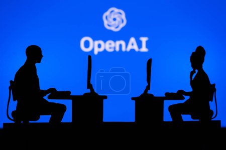 Foto de JAPAN, TOKYO. JANUARY 30, 2023: Open AI. Innovating the Future: Silhouette of Two Software Developers and the Company's Logo in the Background - Imagen libre de derechos