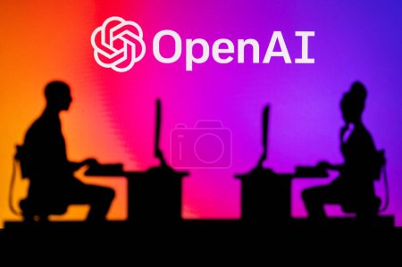 Photo for UK, LONDON. JANUARY 30, 2023: Open AI. Innovating the Future: Silhouette of Two Software Developers and the Company's Logo in the Background - Royalty Free Image