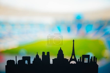 Foto de Paris Unveiled: Silhouette of the City 's Iconic Landmarks, Back dropped by a Modern Sports Stadium (en inglés). Una instantánea de los Juegos de Verano 2024 en París - Imagen libre de derechos