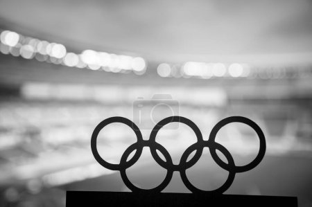 Photo for PARIS, FRANCE, JULY 7, 2023: Black and White photo. Silhouette of Olympic Rings Embracing a Modern Olympic Stadium in the Background. Paris Summer Olympic Game 2024. - Royalty Free Image