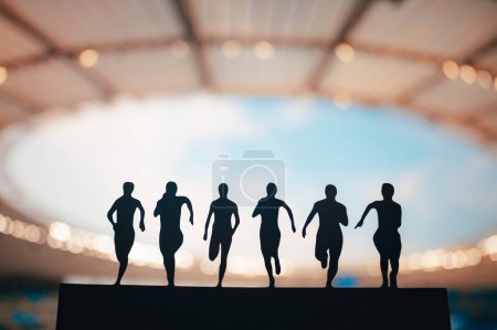 Foto de Unified in Motion: Silhouette of Sprinters Showcasing Strength and Determination at Modern Stadium (en inglés). Juegos de verano de atletismo 2024 en París. - Imagen libre de derechos
