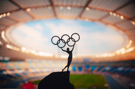 Photo for PARIS, FRANCE, JULY 7, 2023: Black and White Photo. Olympic Spirit: Statue of Athlete Holds Olympic Circle High at Modern Olympic Stadium. Capturing the Essence of Paris 2024 Summer Olympics. - Royalty Free Image