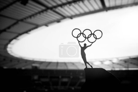 Photo for PARIS, FRANCE, JULY 7, 2023: Inspiring Strength: Statue of Female Athlete Elevates Olympic Circle at Modern Olympic Stadium. Sports Photo for Paris 2024 Summer Olympic Games. - Royalty Free Image