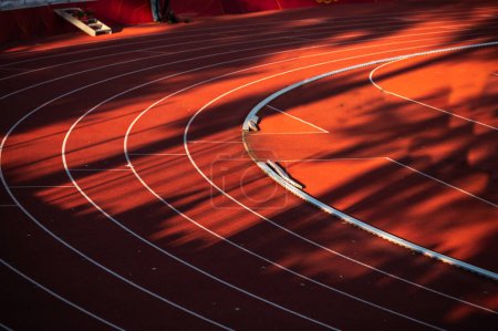 Photo for The Impeccable Geometry of White Lines and Numbered Lanes on the Bold Canvas of a Red Track - Track and Field Illustration Photo for Worlds in Budapest and Games in Paris - Royalty Free Image