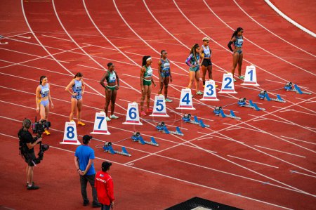 Photo for OSTRAVA, CZECHIA, JUNE 27, 2023: Women Sprinters Prepare for 100m Hurdles Race Commencement in Track and Field Championship for Worlds in Budapest and Games in Paris - Royalty Free Image