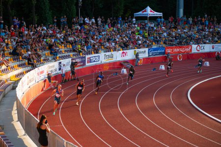 Photo for B. BYSTRICA, SLOVAKIA, JULY 20, 2023: Male Sprinters Competing in 400m Race Under Captivating Sunset Light: Track and Field Event for Worlds in Budapest and Summer olympic Games in Paris - Royalty Free Image