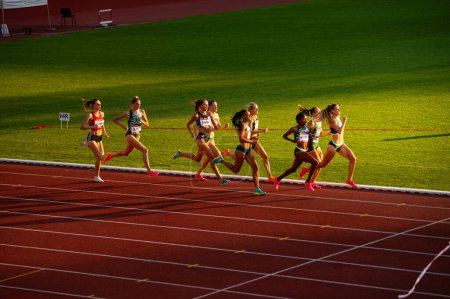 Photo for B. BYSTRICA, SLOVAKIA, JULY 20, 2023: Radiant Sunset Ambiance: Women's 800m Race Unfolds in Captivating Evening Glow at Track and Field Contest for Worlds in Budapest and Summer olympic Games in Paris - Royalty Free Image