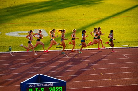 Photo for B. BYSTRICA, SLOVAKIA, JULY 20, 2023: Elegance in Motion: Female Athletes Excel in 800m Run under Picturesque Sunset Light at Track and Field Venue for Worlds in Budapest and Summer olympic in Paris - Royalty Free Image