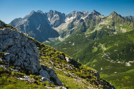 Photo for Mountain landscape, where the High Tatras meet the Belianske Tatras, bathed in sunlight and surrounded by emerald-green meadows - Royalty Free Image