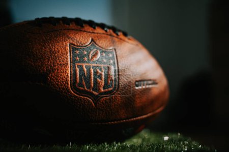 Photo for NEW YORK, USA, SEPTEMBER 11, 2023: NFL Game Ball: Logo in Focus - Official Ball of National Football League - Royalty Free Image