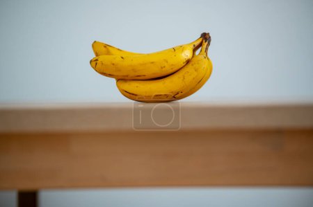 Photo for A kitchen tableau: banana bathed in natural light - Royalty Free Image